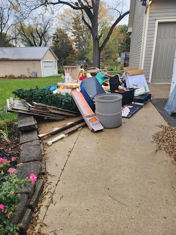 Dumpster being loaded with debris for 12 Yard Dumpster Rental in South Pasadena